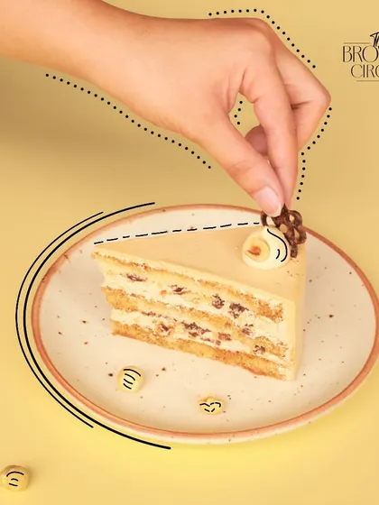 The Coffee Hazelnut pastry is a crowd-pleaser. This slice shows the layers of coffee-soaked cake and crunchy hazelnut cream.
