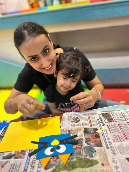 A mother and daughter share a smile as they work on their craft, showing the strong bond our program helps to nurture.