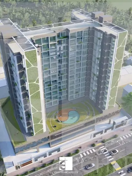 An aerial view of a competition proposal for a large residential complex. This design incorporates vertical green panels on the facade, introducing a sustainable and biophilic element to the high-rise structure.