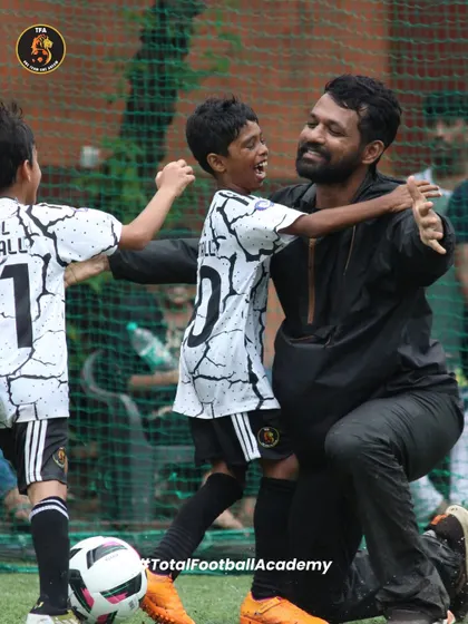 More than just a team, we are a family. A moment of pure joy and connection between a player and his coach, capturing the mentorship and supportive environment we foster.