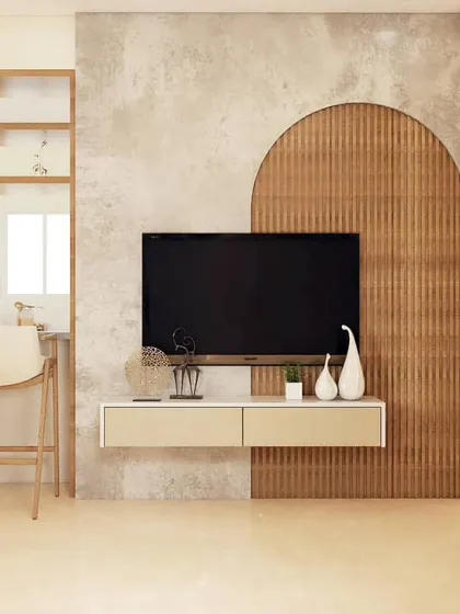This TV unit design plays with shapes and textures, featuring a fluted wood arch set against a concrete-finish wall. The simple floating console provides storage without detracting from the artistic backdrop.