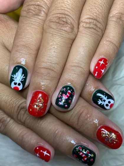 A fun and festive Christmas character manicure, with hand-painted reindeer, Christmas trees, and candy canes.