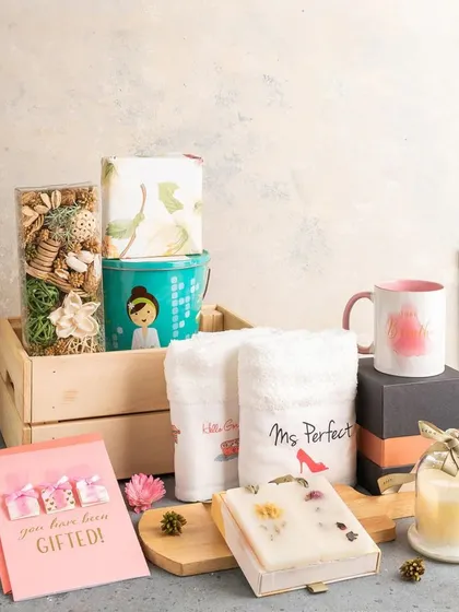 This "Bride to Be" hamper is designed for pampering, with personalized "Ms. Perfect" towels, a scented candle, a mug, and other spa-like goodies in a wooden crate.