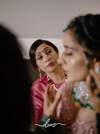 A touching, candid moment between the bride and her mother during the getting-ready process, a look of love and pride shared between them.