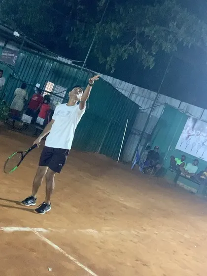 Practicing the serve motion at night. Our well-lit courts allow players to work on their technique at any hour.