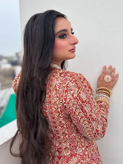 A side profile of this grand party look, showing off the long, flowing hair and the intricate jacket.
