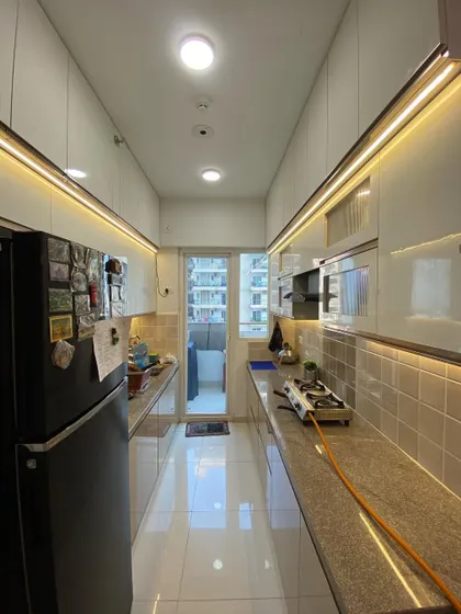 A full view of a completed parallel kitchen. The design maximizes storage with floor-to-ceiling cabinets on both sides.