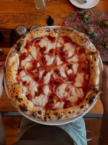 Another look at our Goan Sausage pizza, a perfect circle of deliciousness.