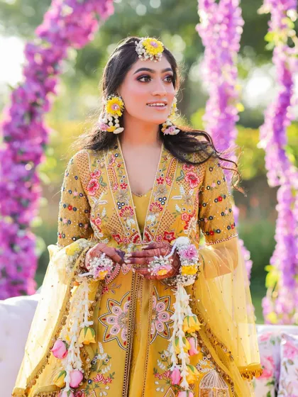 A beautiful portrait of the bride, adorned with fresh floral jewelry for her Haldi ceremony. We focus on capturing the delicate details and the bride's radiant glow.