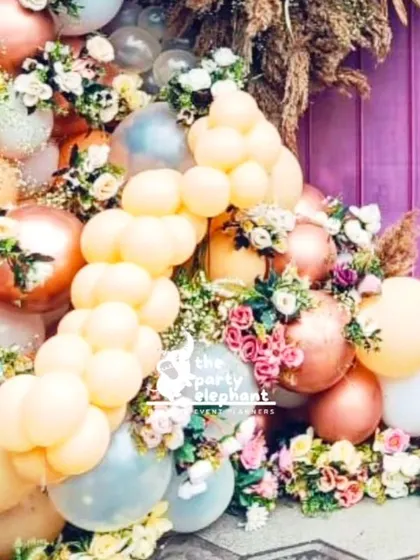 A close-up of the beautiful balloon garland from the rustic baby shower, showing how I weave fresh flowers and greenery among the balloons for a soft and elegant look.