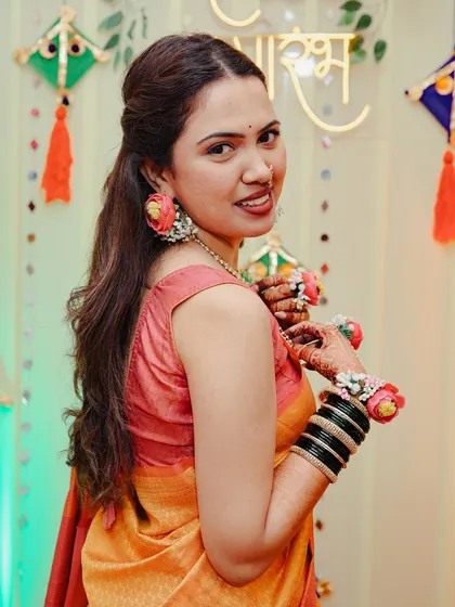 The bride looking over her shoulder with a smile at her Haldi function.