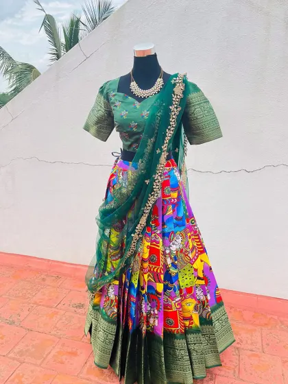 A Kalamkari print lehenga with a green blouse and matching dupatta.