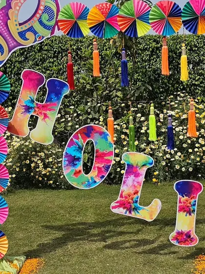 Another angle of our popular Holi photo arch, perfect for outdoor garden parties. The bright colors stand out beautifully against the green background, creating an ideal spot for festive pictures.