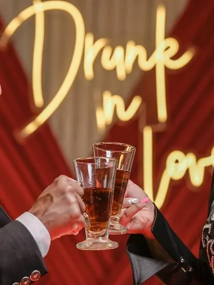 A toast to love and laughter. This close-up of the couple clinking glasses is a perfect celebration of their union.