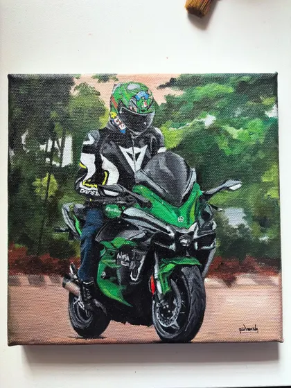 The final commissioned painting of the biker on his green motorcycle.