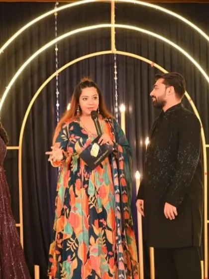 In conversation with the couple on stage, making them feel comfortable and celebrated. These personal interactions are key to making a large event feel intimate and heartfelt.