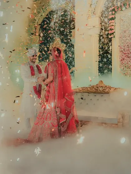A magical Varmala moment. The couple is surrounded by smoke and sparklers, creating a stunningly cinematic and romantic photograph of their garland exchange.
