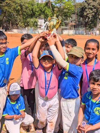 A team of our youngest champions hoisting their trophy. This moment captures the culmination of their hard work, teamwork, and the guidance of their coaches.