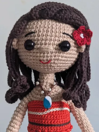 A close-up of my Moana doll, showing the detail on her face, her necklace, and her wavy brown hair.