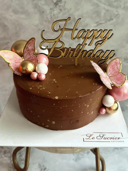 My Decadent Chocolate Cake customized with delicate pink butterflies and spheres, showing how a classic flavor can be dressed up for any theme.