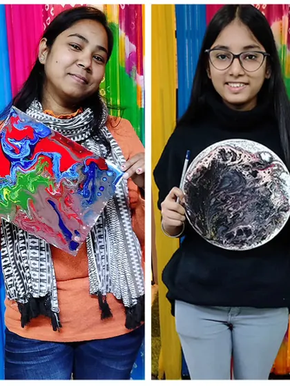 Two students showing off their unique fluid art creations. It's always exciting to see the different results that come from the same set of instructions.
