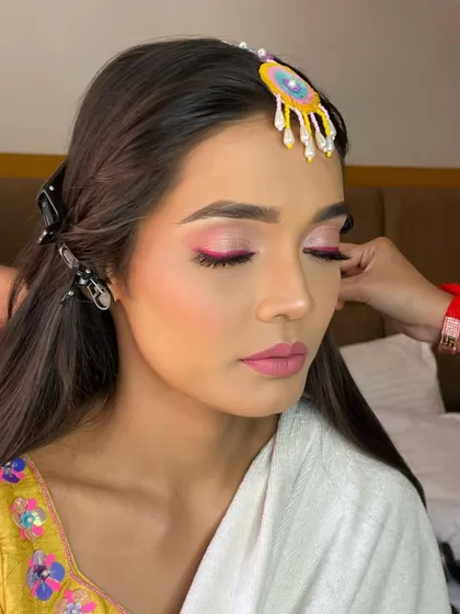 A close-up of the makeup application, showing the pop of pink on the eyelids.