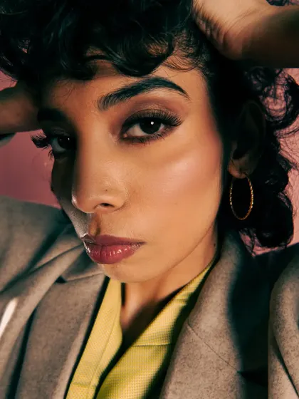 A powerful close-up portrait that conveys the stress and glamour of the fashion world. The expression is key to the narrative.