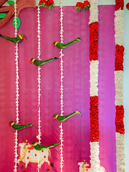 A close-up of the traditional decor, featuring parrot and cow hangings made of leaves and flowers, showcasing our commitment to authentic craftsmanship.
