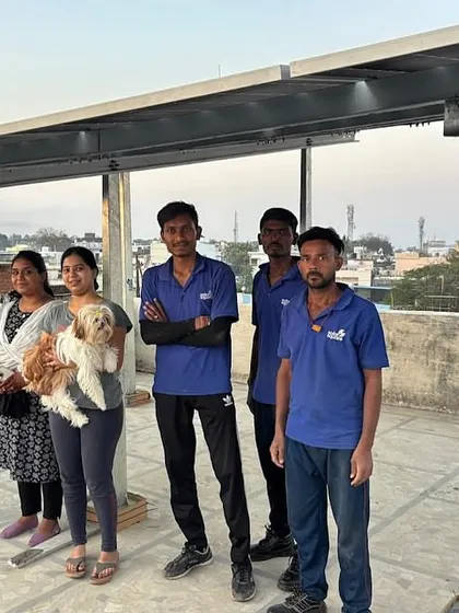 Our installation crew posing with a happy customer and her dog. We love seeing the whole family get excited about their new solar system.