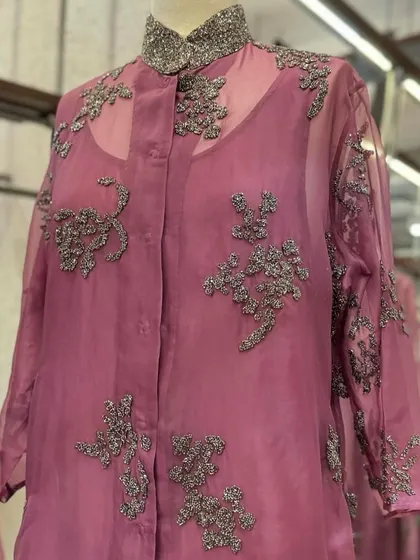 A sheer organza jacket in a deep mauve, featuring intricate silver floral embroidery, a beautiful layering piece from Peachoo.