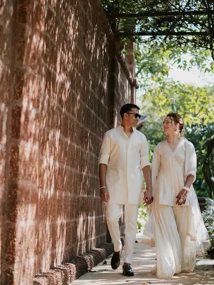 For their Haldi, Rachael and Viraj chose to stand out in coordinated ivory. I designed a custom tone-on-tone kurta for him and a sharara set for her, creating a unique and elegant look.