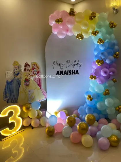 A full view of the pastel rainbow princess party setup, showing the arrangement in a home living room.