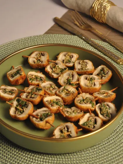 My Mushroom Duplex is a sophisticated vegetarian appetizer. These are mushrooms stuffed with a savory filling, coated, and fried, then sliced to reveal the delicious interior.