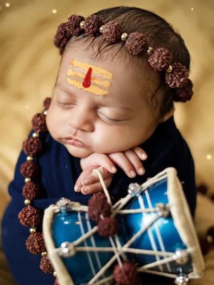 A close-up of the newborn Shiva, with a tripundra on his forehead. We handle every detail with care and respect for the theme.