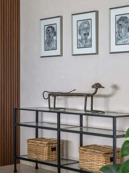 A console table in Apartment 1600, where we curated art and objects to reflect the client's personality. The fluted wood paneling adds texture to the wall.