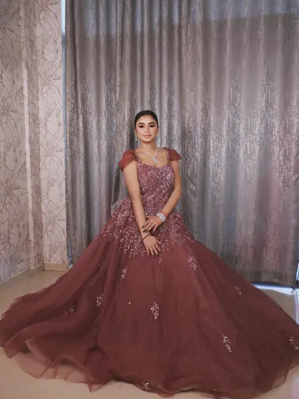 This pose captures the beautiful structure of the gown and its intricate silver embroidery.