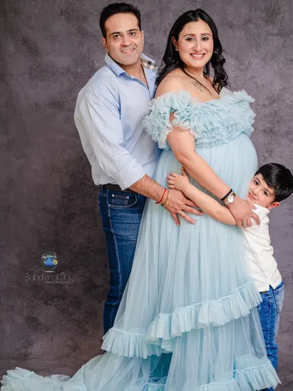 A beautiful family maternity portrait in our studio. We love when older siblings get to be part of the excitement, sharing a hug with their future brother or sister.
