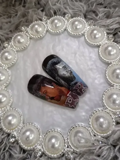 For the movie buffs, here are two nails from a set inspired by the film "RRR," featuring hand-painted portraits of the main characters.