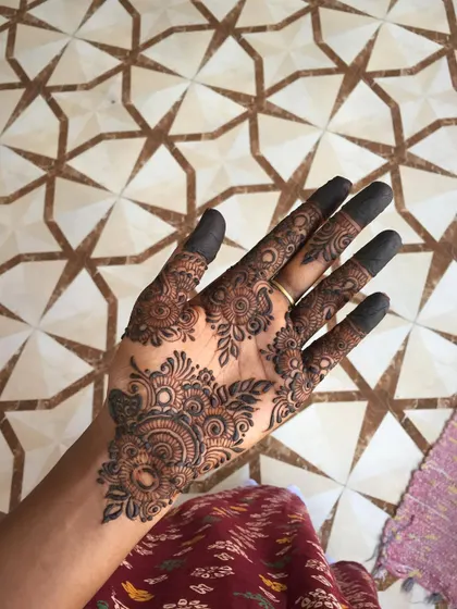 An intricate and beautiful design for the palm, featuring a central mandala and detailed floral work.