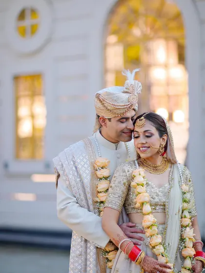 A classic portrait of the couple in their beautiful day-wedding attire, sharing a quiet, happy moment together.