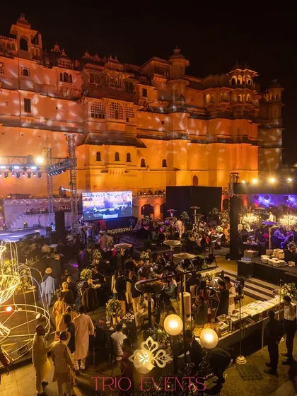 The view of the Sangeet celebration with the majestic City Palace Udaipur as the backdrop. My planning ensures that the venue itself becomes the most spectacular element of your event's decor.