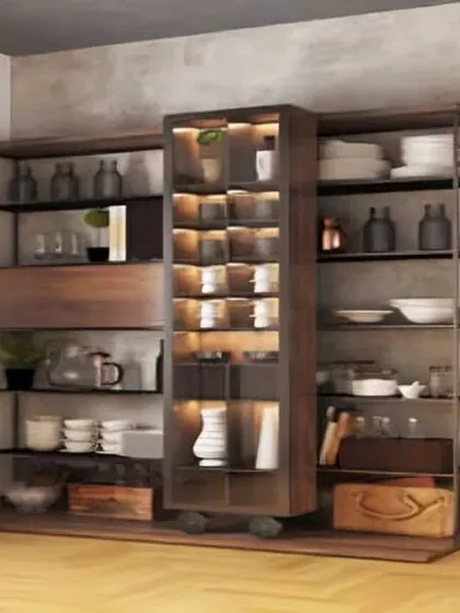 An industrial-style open-shelf crockery unit made of dark wood and metal. The central glass cabinet with lighting is perfect for highlighting special items.