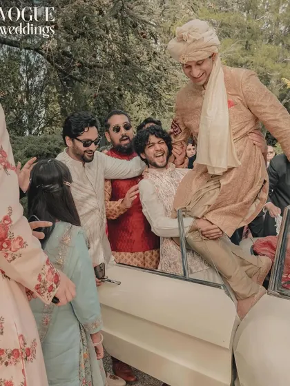The groom's energetic baraat entrance, a moment of fun and celebration with friends, as seen in Vogue Weddings.