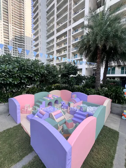 Our pastel soft play area set up in an urban garden, showing how we can create a fun and safe play zone even in city environments.