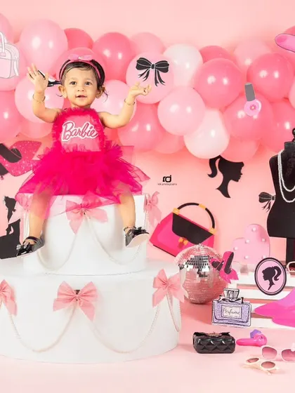 On top of her birthday cake, this Barbie girl is the star of the show.