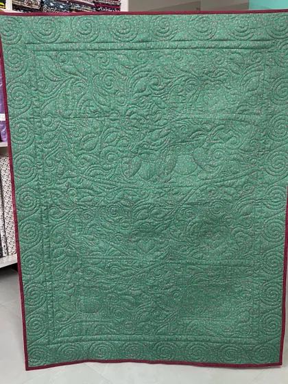 The back of the owl quilt, where the quilting creates a beautiful silhouette of the design.