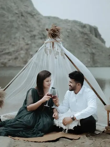 A toast to their future together. This styled pre-wedding picnic setup by the lake provides a perfect opportunity for romantic and celebratory photos.