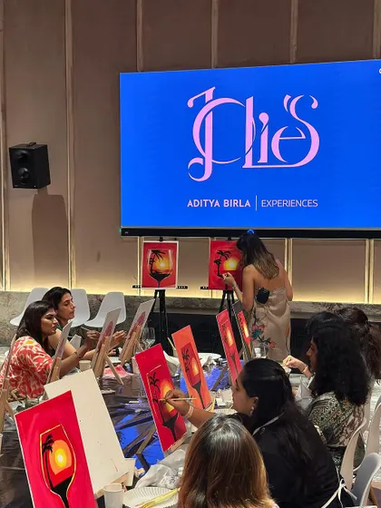 A shot from behind the easels at the Club Jolies event, showing me demonstrating the painting technique on stage.