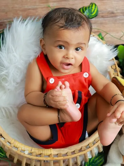 Look at those tiny toes. This shot captures the sweet details and playful curiosity of a six-month-old during his jungle adventure shoot.
