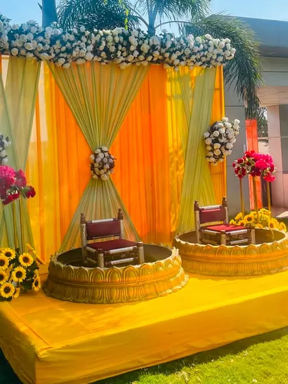 Another angle of the classic outdoor Haldi ceremony stage. This view shows the full setup on a sunny day, highlighting the bright colors and floral details.